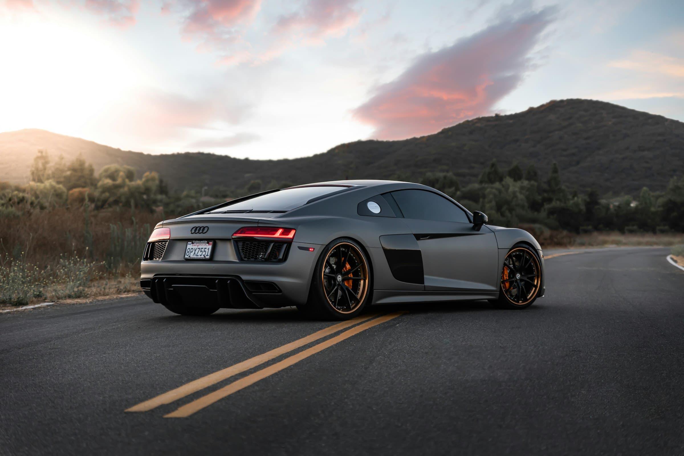 Protected matte grey sports car at dusk